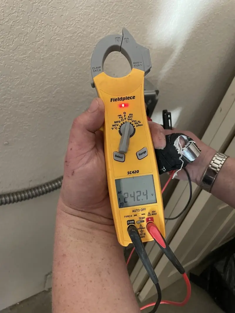 Voltage testing with clamp meter during Recessed Lighting Installation in Cuba
